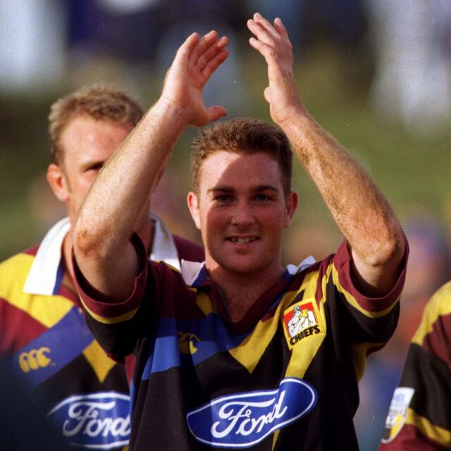 Chiefs player applauds the crowd after a match, reflecting pride and gratitude.