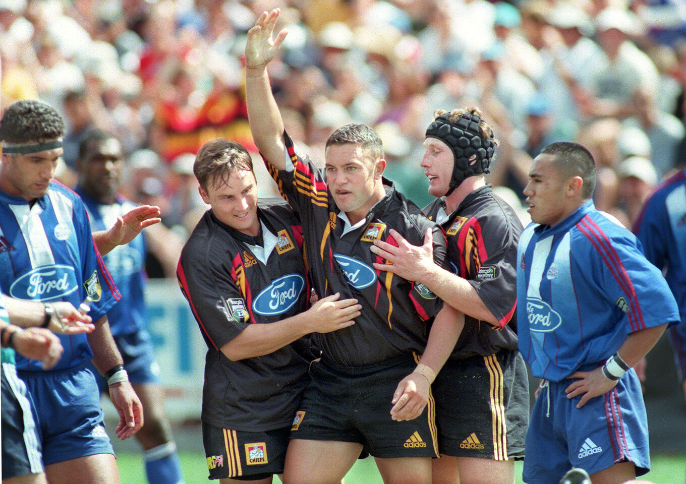 Chiefs players celebrate a try during a Super Rugby game.