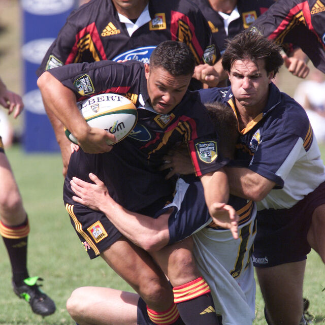 Chiefs forward drives through defenders during an early Super Rugby match, showcasing power and commitment.