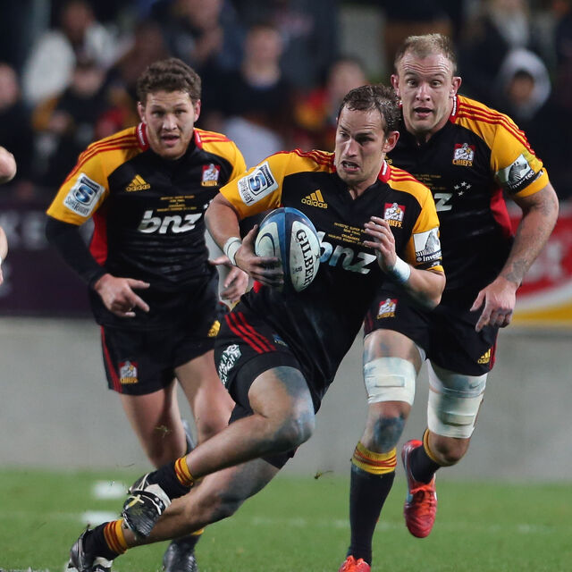 Chiefs backline player breaks through opposition defence with teammates in support.