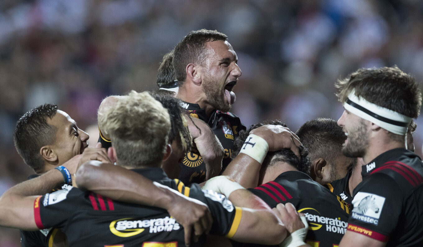 Chiefs players embrace after scoring, showing unity and pride.