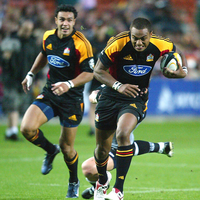 Chiefs winger sprints clear of defenders to score a try.